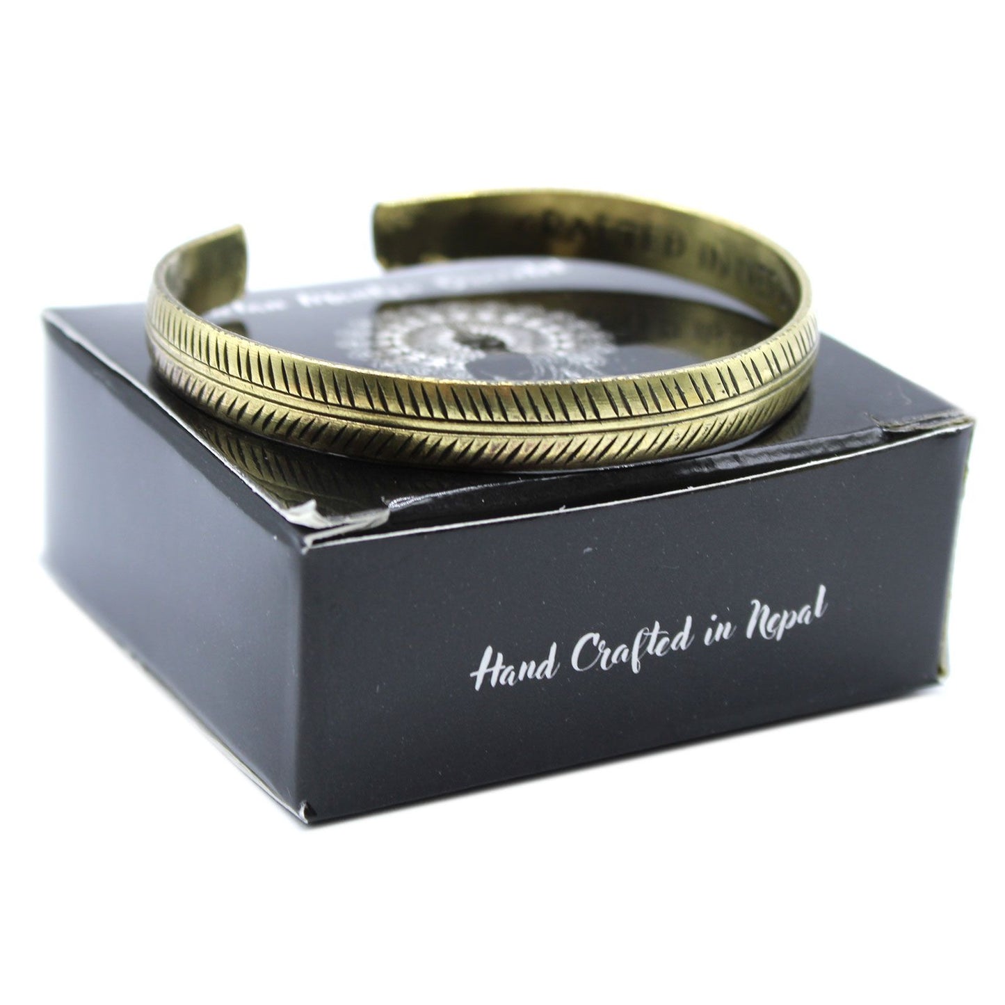 Brass Tibetan Bracelet on a black box with 'Hand Crafted in Nepal' text