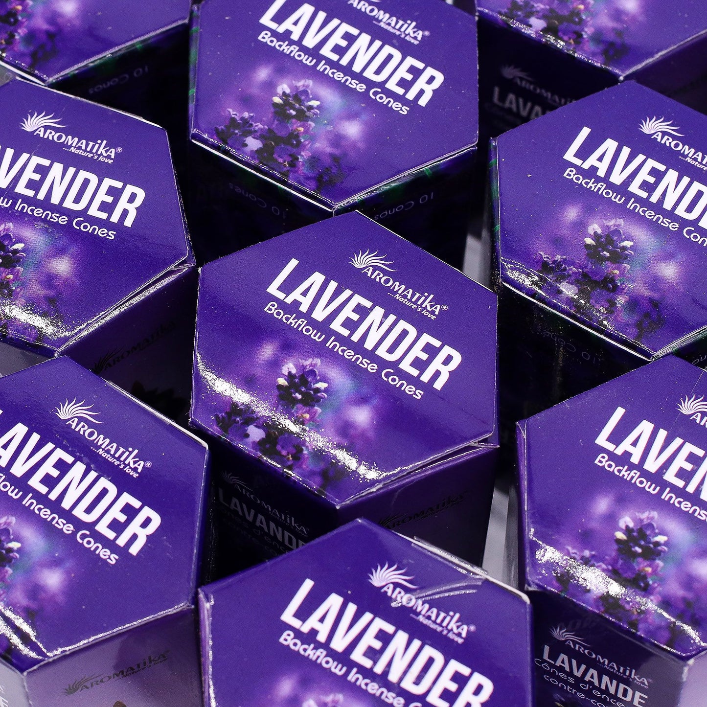 Multiple boxes of Aromatika Lavender Backflow Incense Cones on a reflective surface.
