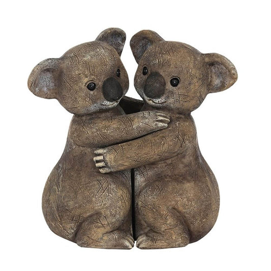 koala bears hugging ornament on white background
