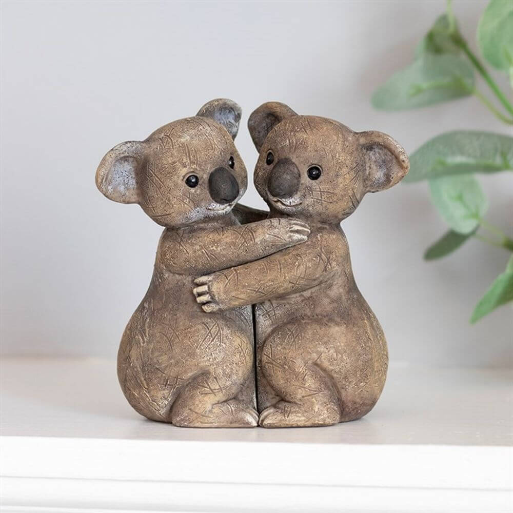 koala bears hugging ornament on white background